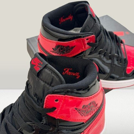 Close-up of Jordan 1 Patent-Bred heel tab and Wings logo embossing