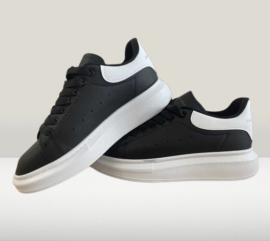 Stylish Alexander McQueen Black sneakers with white accents

